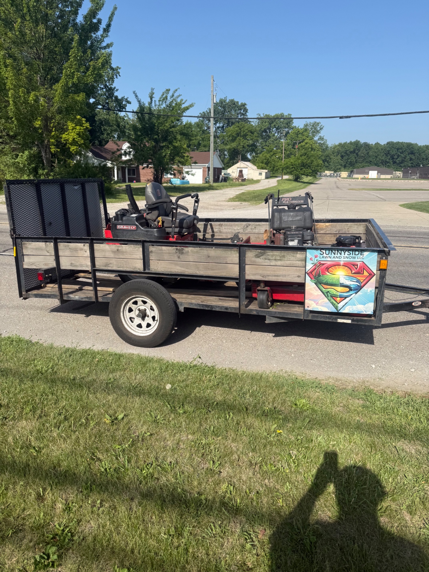 Sunnyside Lawn and Snow trailer loaded with a zero-turn mower and equipment